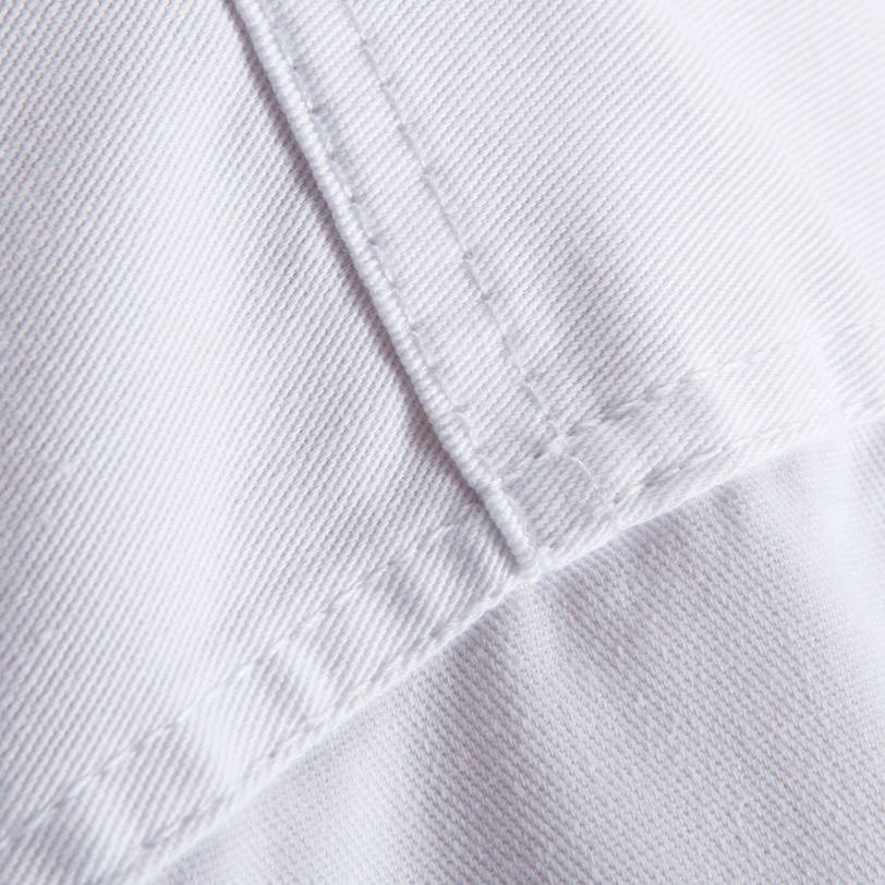 Macro shot of reinforced heavy-duty stitching on high-stress areas of the QTKU-001 martial arts